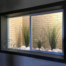 Faux brick wall panels inside a window well